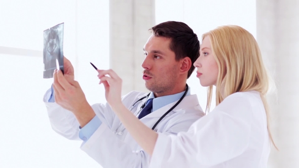 Two Doctors Discussing X-ray Image At Hospital 38