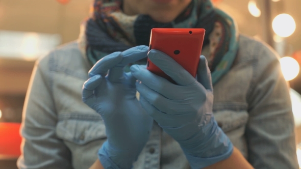 Master Holding a Phone Red In Blue Rubber Gloves
