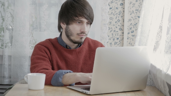 Happy Young Man Freelancer With Modern Laptop In Cafe Taking Cup Of Coffee