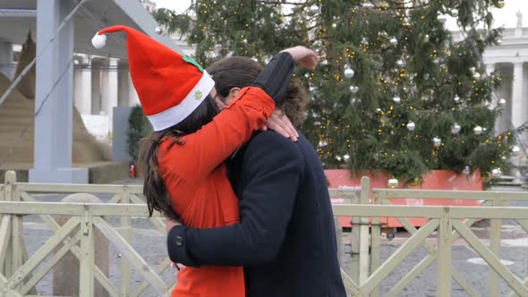 Happy Young Couple Hugging in The City at Christmas