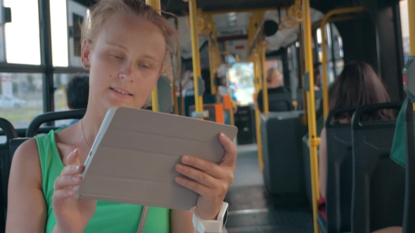 Smiling Woman With Tablet In Bus