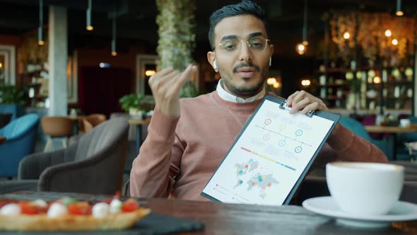 Portrait of Arab Businessman Making Report During Online Video Call in Cafe