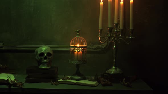 Mystical Halloween still-life background. Skull, candlestick with candles, old fireplace.