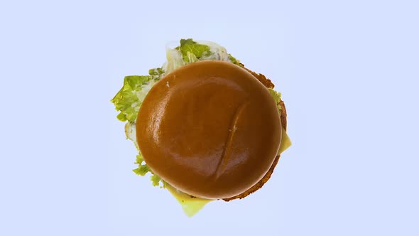 Fatty Hamburger Spinning on White Background, Unhealthy Junk Food, Top View