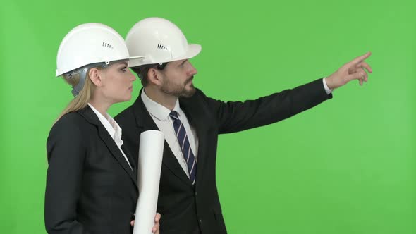 Two Engineers Looking at Construction Work Against Chroma Key