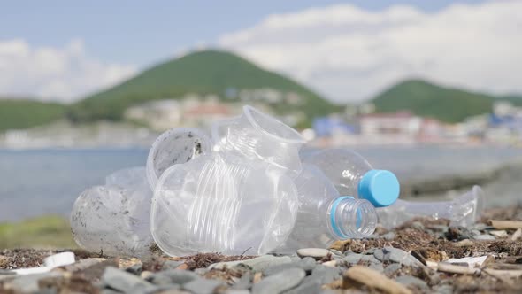 Plastic Bottles and Other Trash on Sea Beach. Empty Used Dirty Plastic Bottles. Environmental