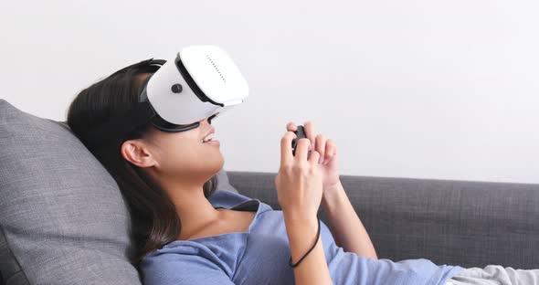 Woman watching with VR device on sofa