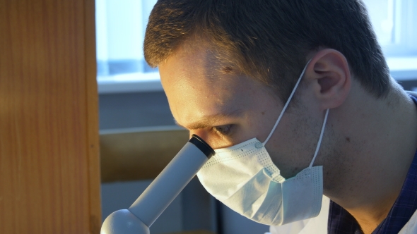 A  Of a Laboratory Technician, Doctor, Biologist, Or Scientist Looking Through a Microscope. 