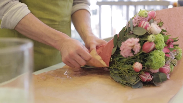 Florist Wrapping Flowers In Paper At Flower Shop 26