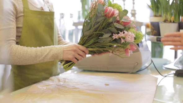 Florist Wrapping Flowers In Paper At Flower Shop 16