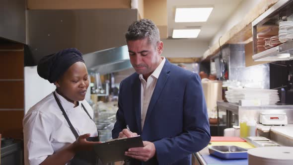 Caucasian man talking to a chef