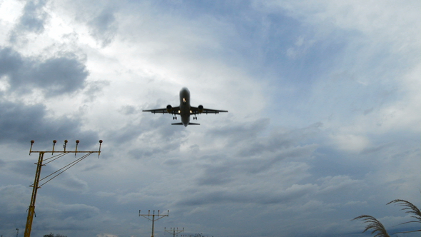 Airplane Arriving to Airport at a Cloudy Day