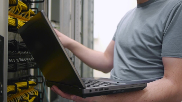 IT Engineer Checks The Server Rack 