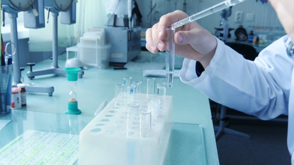 Male Hand Of Doctor Scientist Fill a Test Tube Of Liquid