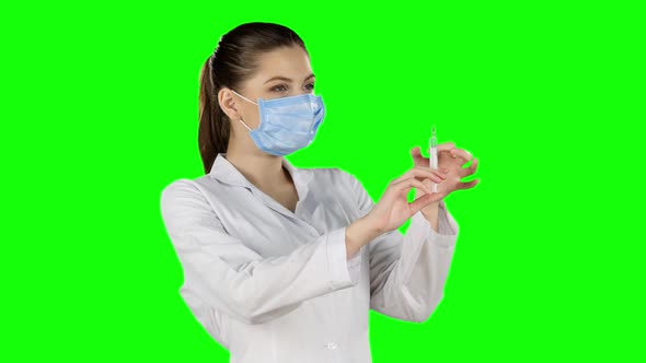 Young Doctor with Injection. Green Screen. Closeup