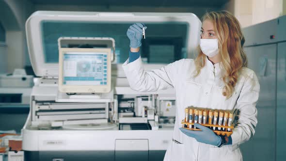 Portrait of a Lab Worker with Blood Sampling Tubes in Her Hands. Laboratory for the Study of