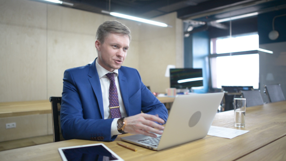 Businessman Talking with Client in Office