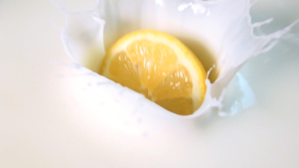 Half Of Lemon Drops Into The Milk