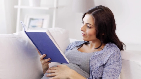 Happy Pregnant Woman Reading Book At Home 32