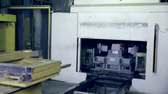 Robot Making Car Parts At Factory. Automative Metal Casting.
