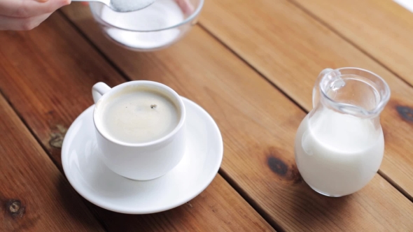 Hand Pouring Sugar By Teaspoon Into Coffee Cup 45