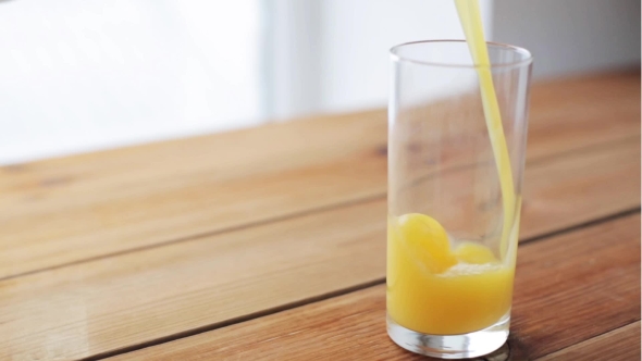 Orange Juice Pouring Into Glass On Wooden Table 6
