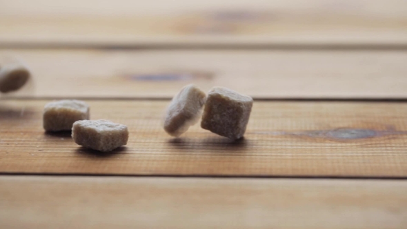 Brown Lump Sugar Pouring On Wooden Board Or Table 33