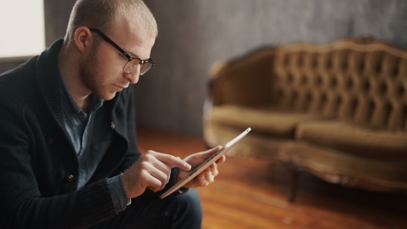 Portrait Of A Handsome Young Happy Man Using Digital Tablet