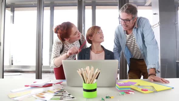 Female Creative Executive Showing To Director And Colleague Project On Laptop 2