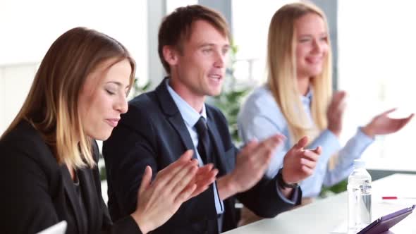 Business People Clapping Their Colleague After Presentation