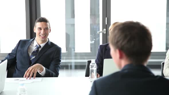 Business People Sitting At Table In Conference Room And Listening Presentation 1