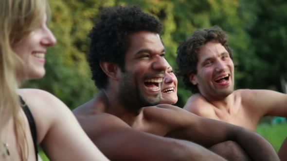 Four Friends Laughing While Sitting In Nature 3
