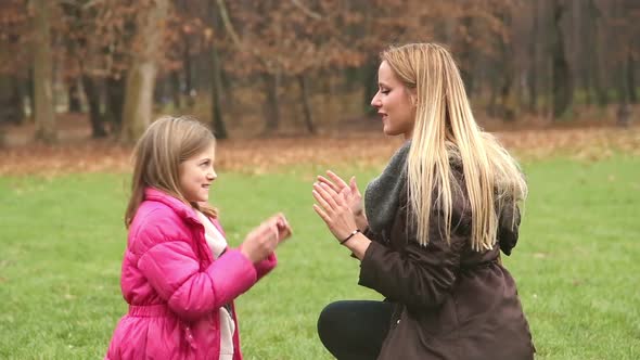 Mother And Daughter Playing Clapping Game