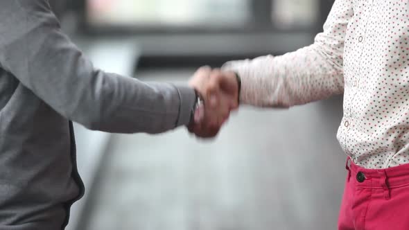 Two Advertising Executives Shaking Hands
