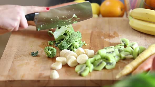 Close-Up Of Cutting Broccoli With Knife 1