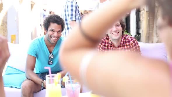 Two Male Friends Sitting On Terrace Cafe In Summer 4