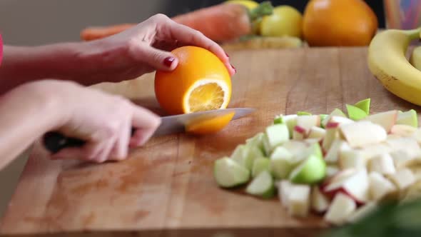 Close-Up Of Cutting Orange With Knife 1