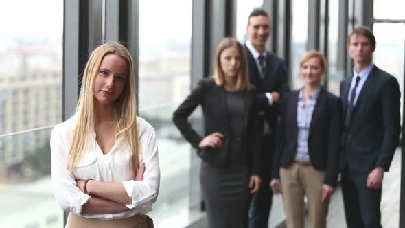 Portrait Of Attractive Businesswoman Smiling, Colleagues In Background 1