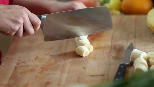 Close-Up Of Cutting Peeled Banana With Knife 1