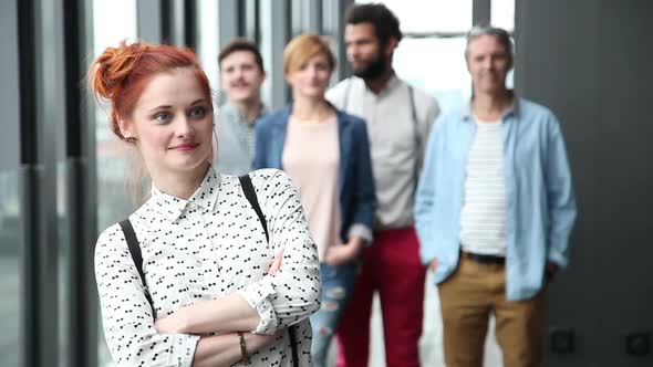 Portrait Of Beautiful Female Advertising Executive, Colleagues In Background