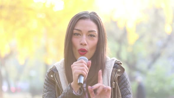 Portrait Of Beautiful Woman Singing With Microphone 1