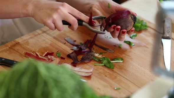 Close-Up Of Peeling Beetroot With Peeler