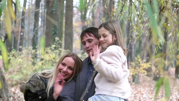 Portrait Of Beautiful Young Family Waving