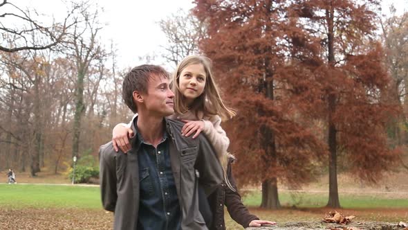 Girl Climbs On Father's Back From Tree Stump 3