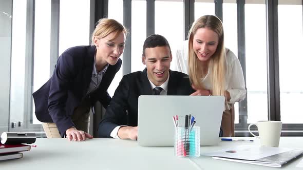 Young Manager And Two Businesswoman With Laptop In Office