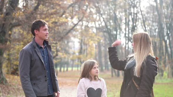 Young Parents Having Fun With Daughter In The Park