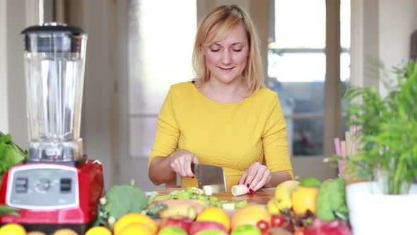 Young Woman Cutting Banana Into Slices