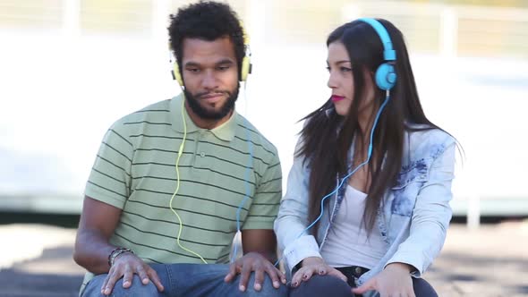 Attractive Couple Having Fun Listening To Music With Headphones 1