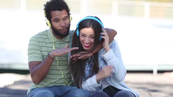 Attractive Couple Having Fun Listening To Music With Headphones 2