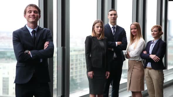 Portrait Of Handsome Businessman Smiling, Colleagues In Background 3